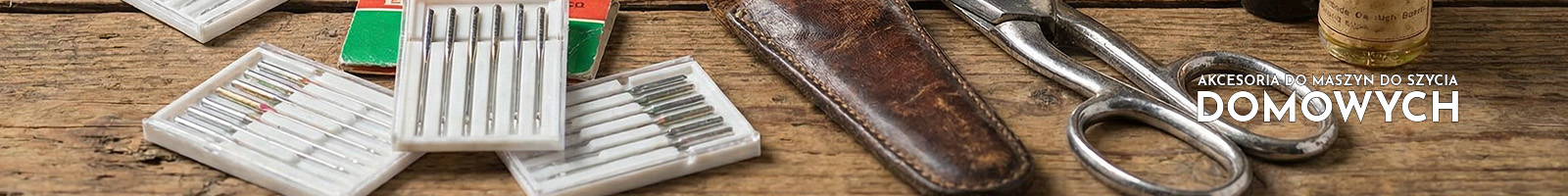 sewing needles, a scissor and oil bottles on a table.