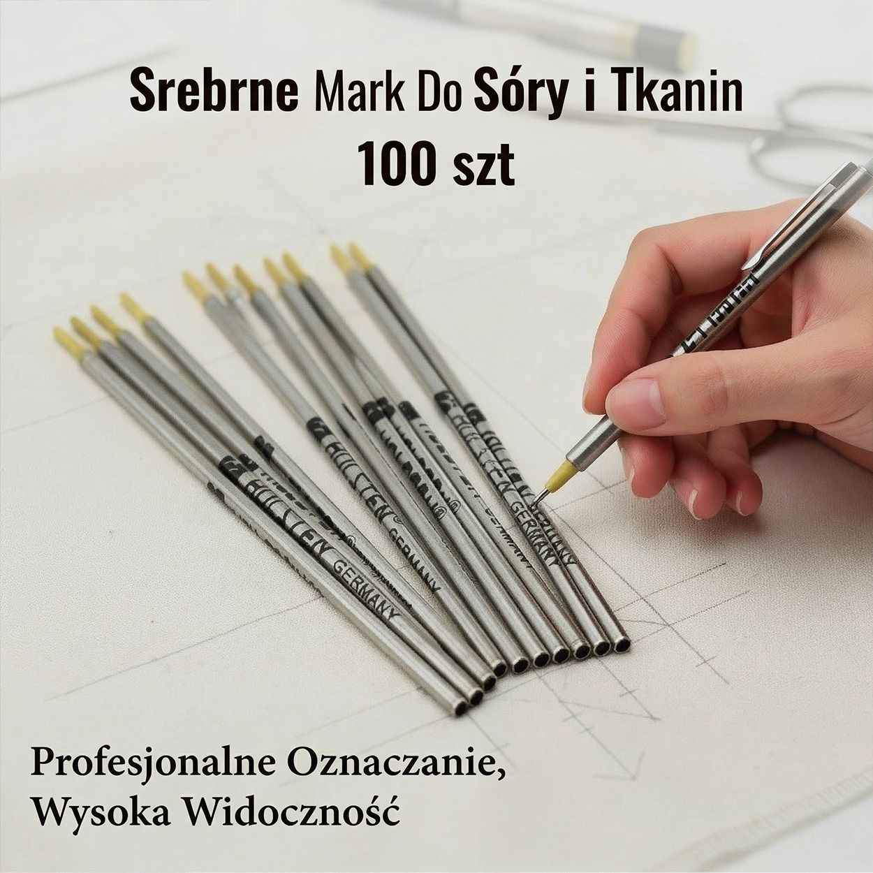 silver pens on the table. a man holding one.